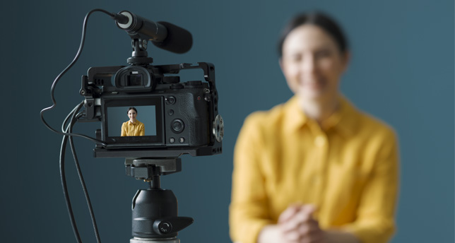 Professional vlogger sitting in front of a camera